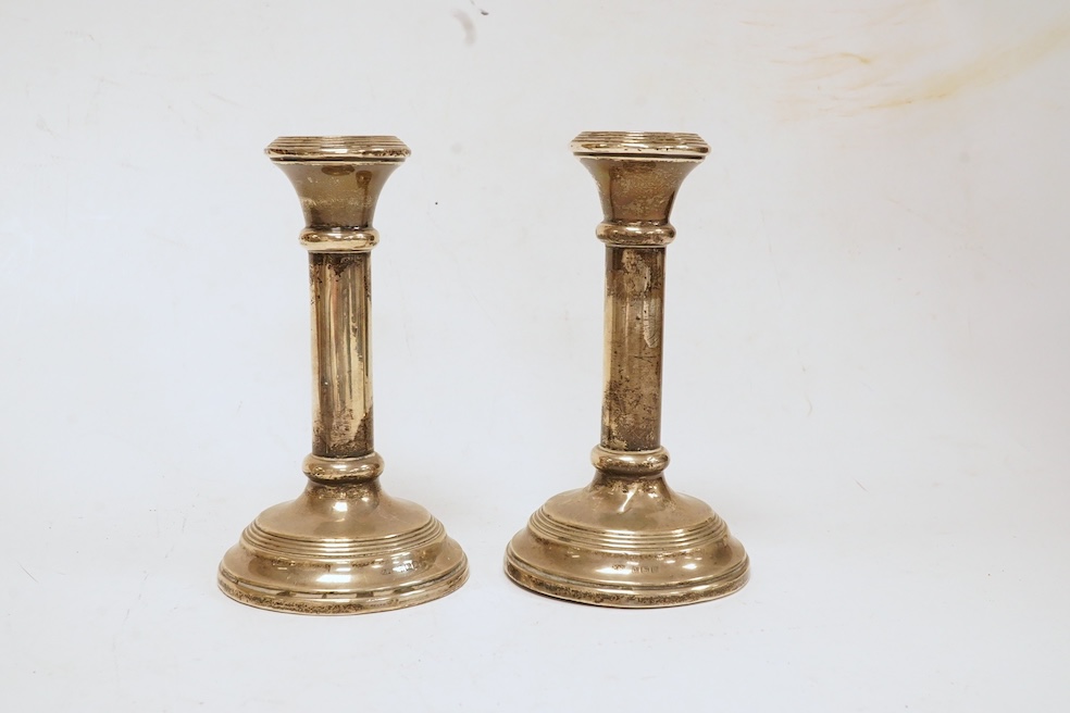 A late Victorian silver small cruet stand, with three mounted glass bottles, all Hukin & Heath, Birmingham, 1897, one associated bottle London, 1891, diameter 10.9cm, together with three assorted silver napkin rings, a s